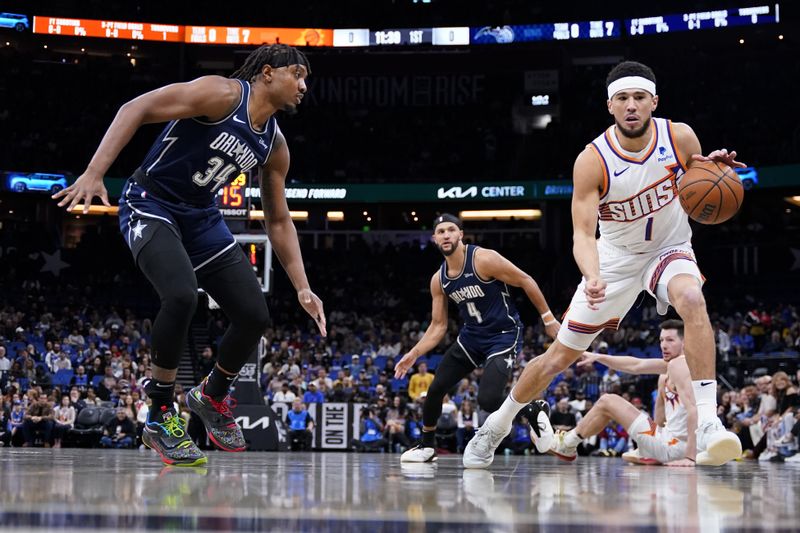 ORLANDO, FLORIDA - JANUARY 28: Devin Booker #1 of the Phoenix Suns dribbles the ball up the court against Wendell Carter Jr. #34 of the Orlando Magic during the first quarter at Kia Center on January 28, 2024 in Orlando, Florida. NOTE TO USER: User expressly acknowledges and agrees that, by downloading and or using this photograph, User is consenting to the terms and conditions of the Getty Images License Agreement. (Photo by Rich Storry/Getty Images)