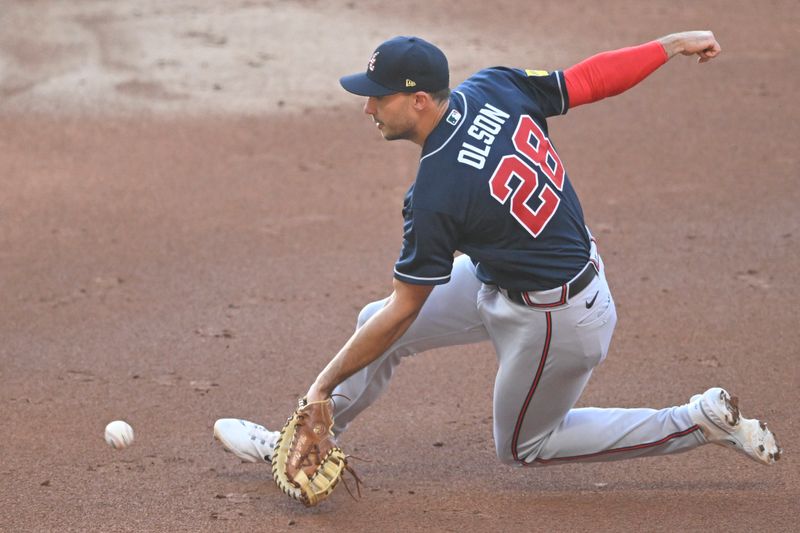 Jul 4, 2023; Cleveland, Ohio, USA; Atlanta Braves first baseman Matt Olson (28) makes a sliding stop of a ground ball in the third inning against the Cleveland Guardians at Progressive Field. Mandatory Credit: David Richard-USA TODAY Sports