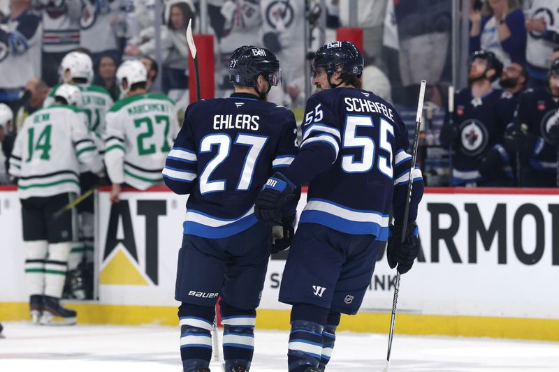 May 9, 2025; Winnipeg, Manitoba, CAN; Winnipeg Jets center Mark Scheifele (55) celebrates the goal by Winnipeg Jets left wing Nikolaj Ehlers (27) against the Dallas Stars in the second period in game two of the second round of the 2025 Stanley Cup Playoffs at Canada Life Centre. Mandatory Credit: James Carey Lauder-Imagn Images