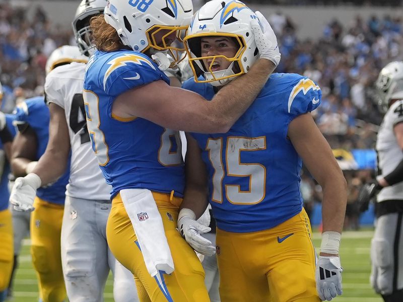 Los Angeles Chargers wide receiver Ladd McConkey (15) is congratulated by tight end Hayden Hurst (88) after scoring a touchdown against the Las Vegas Raiders during the second half of an NFL football game, Sunday, Sept. 8, 2024, in Inglewood, Calif. (AP Photo/Marcio Jose Sanchez)