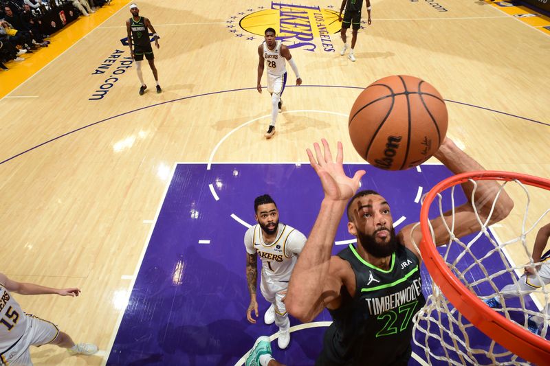 LOS ANGELES, CA - APRIL 7: Rudy Gobert #27 of the Minnesota Timberwolves rebounds the ball during the game against the Los Angeles Lakers on April 7, 2024 at Crypto.Com Arena in Los Angeles, California. NOTE TO USER: User expressly acknowledges and agrees that, by downloading and/or using this Photograph, user is consenting to the terms and conditions of the Getty Images License Agreement. Mandatory Copyright Notice: Copyright 2024 NBAE (Photo by Juan Ocampo/NBAE via Getty Images)