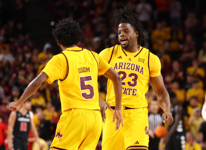 Jan 24, 2026; Tempe, Arizona, USA; Arizona State Sun Devils forward Allen Mukeba (23) celebrates with guard Maurice Odum (5) against the Cincinnati Bearcats in the first half at Desert Financial Arena. Mandatory Credit: Mark J. Rebilas-Imagn Images