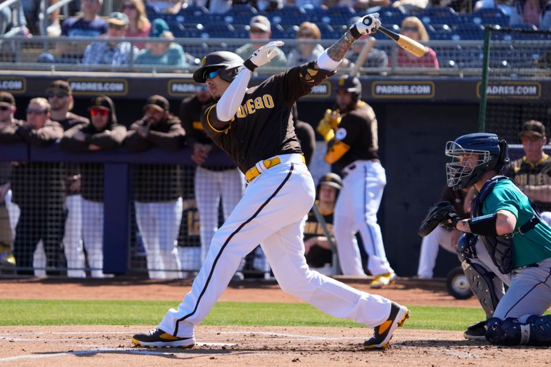 Feb 24, 2023; Peoria, Arizona, USA; San Diego Padres third baseman Manny Machado (13) hits a single against the Seattle Mariners in the first inning at Peoria Sports Complex. Mandatory Credit: Rick Scuteri-USA TODAY Sports