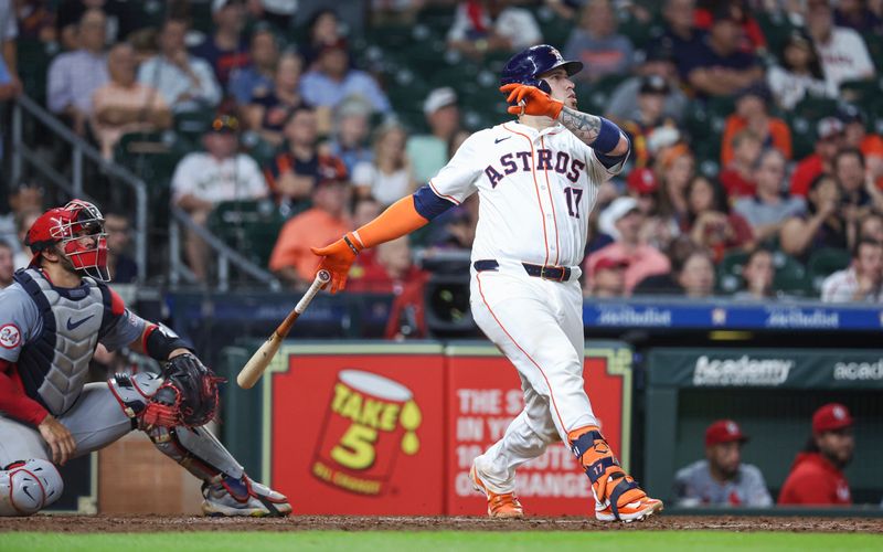 Jun 4, 2024; Houston, Texas, USA; Houston Astros catcher Victor Caratini (17) drives in a run with a sacrifice fly during the seventh inning against the St. Louis Cardinals at Minute Maid Park. Mandatory Credit: Troy Taormina-USA TODAY Sports