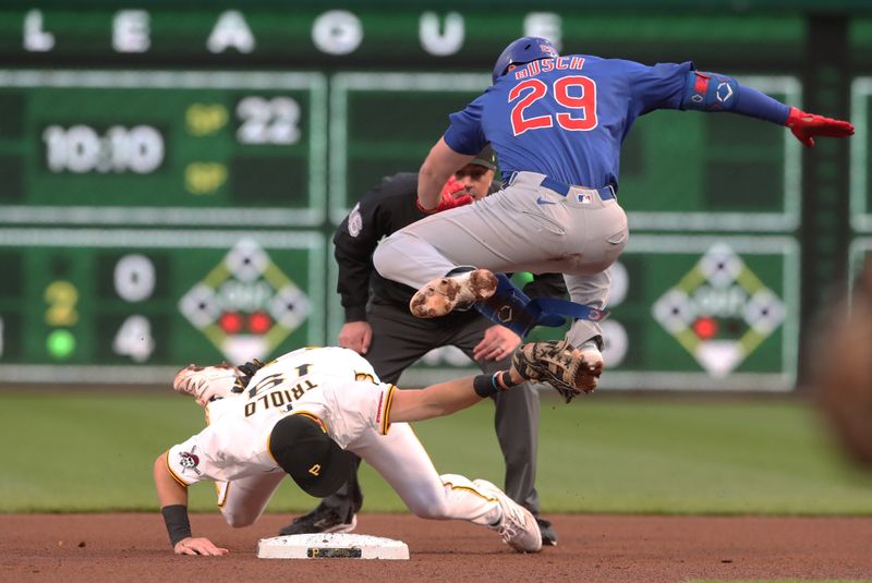Apr 29, 2025; Pittsburgh, Pennsylvania, USA;  Pittsburgh Pirates second baseman Jared Triolo (19) tags out Chicago Cubs first baseman Michael Busch (29) while attempting to stretch a single into a double during the fourth inning at PNC Park. Mandatory Credit: Charles LeClaire-Imagn Images