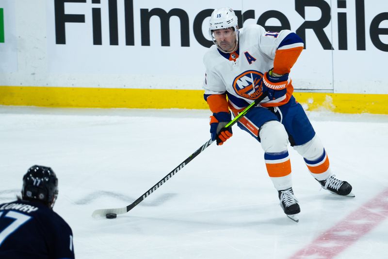 Jan 16, 2024; Winnipeg, Manitoba, CAN; New York Islanders forward Cal Clutterbuck (15) looks to make a pass during the third period against the Winnipeg Jets at Canada Life Centre. Mandatory Credit: Terrence Lee-USA TODAY Sports