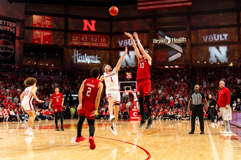 Mar 3, 2024; Lincoln, Nebraska, USA; Rutgers Scarlet Knights guard Gavin Griffiths (10) attempts a three point basket against Nebraska Cornhuskers guard Sam Hoiberg (1) during the second half at Pinnacle Bank Arena. Mandatory Credit: Dylan Widger-USA TODAY Sports