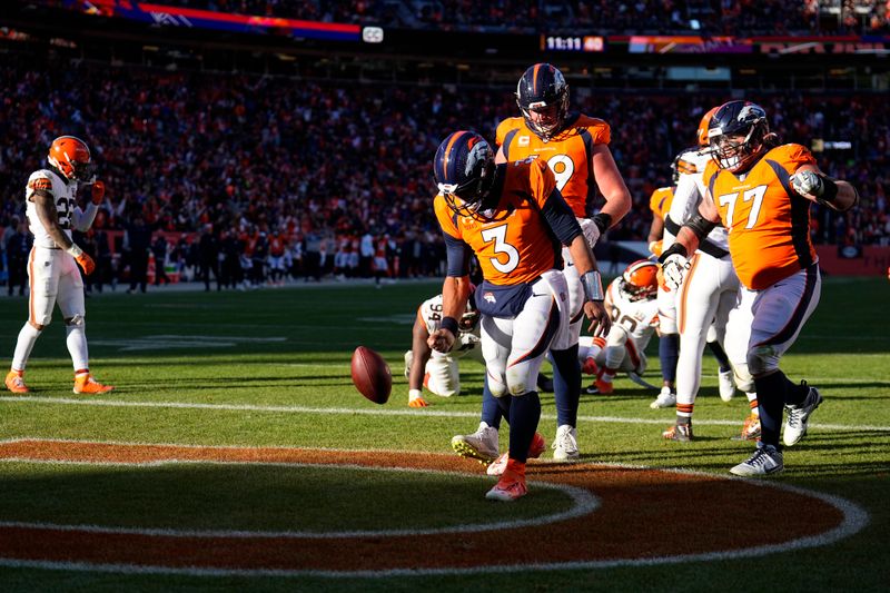 Denver Broncos quarterback Russell Wilson (3) celebrates after scoring during the first half of an NFL football game against the Cleveland Browns on Sunday, Nov. 26, 2023, in Denver. (AP Photo/Jack Dempsey)