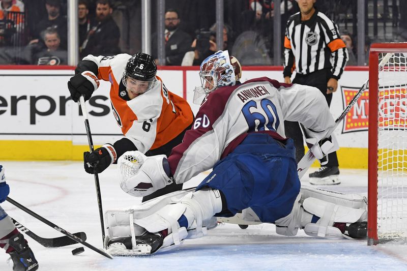 Nov 18, 2024; Philadelphia, Pennsylvania, USA; Colorado Avalanche goaltender Justus Annunen (60) makes a save against Philadelphia Flyers defenseman Travis Sanheim (6) during the third period at Wells Fargo Center. Mandatory Credit: Eric Hartline-Imagn Images