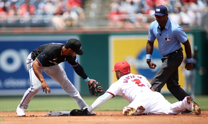 Jun 16, 2024; Washington, District of Columbia, USA; Miami Marlins second base Otto Lopez (61) tags Washington Nationals second base Luis García Jr. (2) out during the second inning in a game at Nationals Park. Mandatory Credit: Daniel Kucin Jr.-USA TODAY Sports