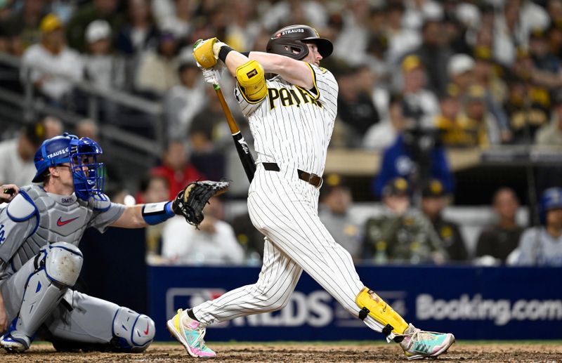 Oct 9, 2024; San Diego, California, USA; San Diego Padres first baseman Jake Cronenworth (9) triples in the seventh inning against the Los Angeles Dodgers during game four of the NLDS for the 2024 MLB Playoffs at Petco Park.  Mandatory Credit: Denis Poroy-Imagn Images