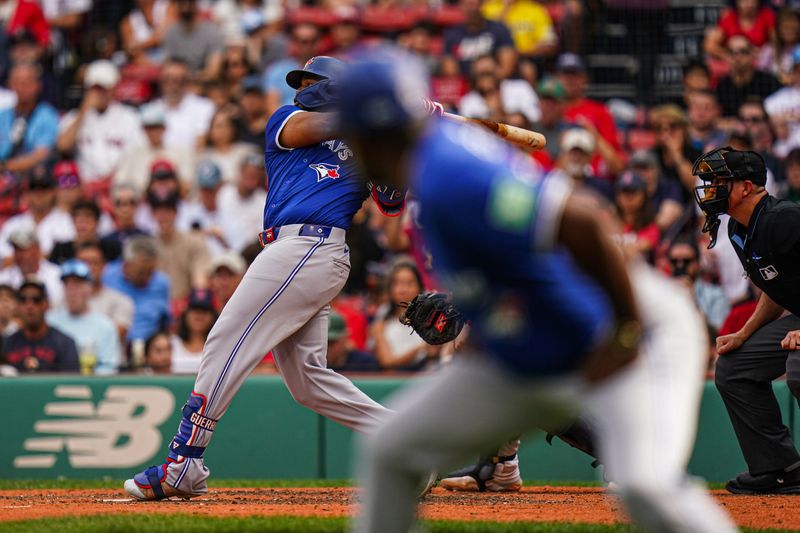 Aug 26, 2024; Boston, Massachusetts, USA; Toronto Blue Jays first baseman Vladimir Guerrero Jr. (27) hits a double to drive in two runs against the Boston Red Sox in the eighth inning at Fenway Park. Mandatory Credit: David Butler II-USA TODAY Sports