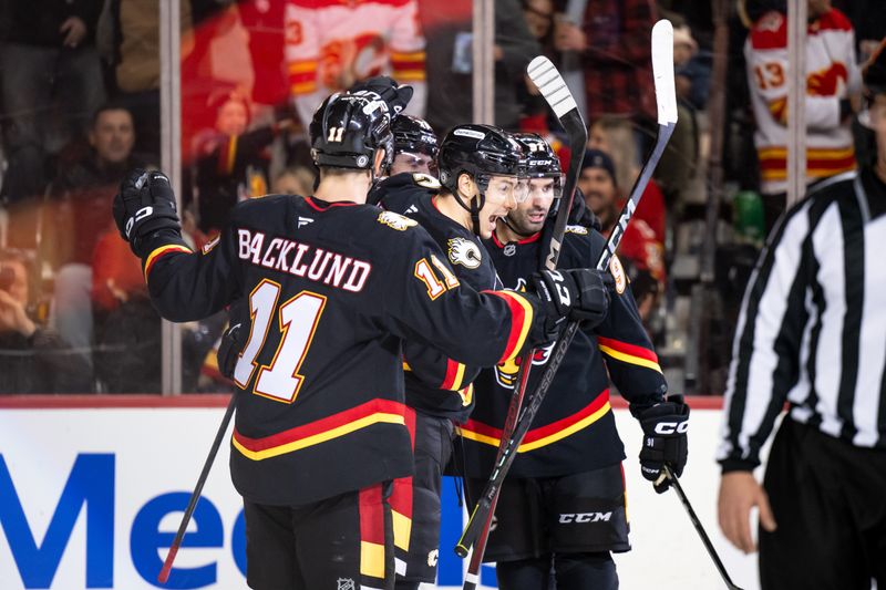 Nov 23, 2024; Calgary, Alberta, CAN; Calgary Flames center Martin Pospisil (76) celebrates with teammates after a goal against the Minnesota Wild during the second period at Scotiabank Saddledome. Mandatory Credit: Brett Holmes-Imagn Images