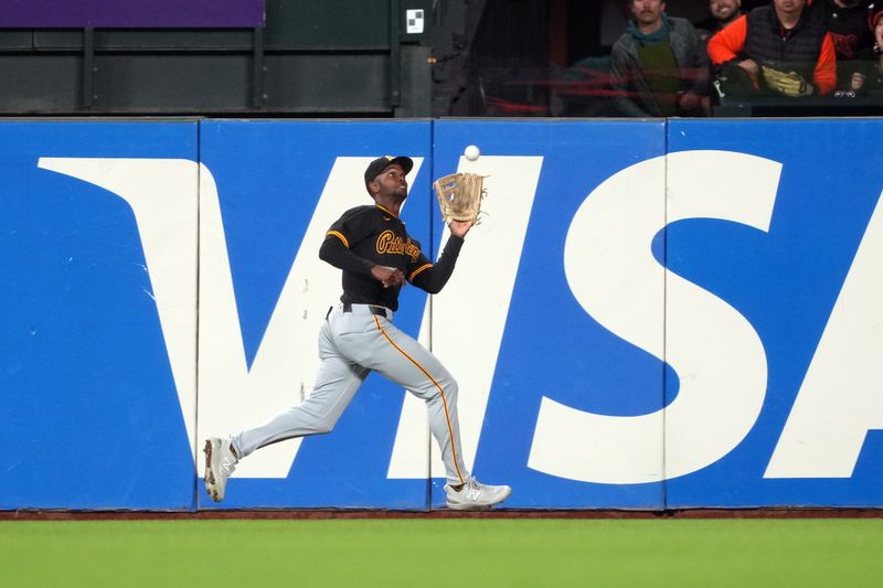 Apr 26, 2024; San Francisco, California, USA; Pittsburgh Pirates center fielder Michael A. Taylor (18) catches a fly ball against the San Francisco Giants during the fifth inning at Oracle Park. Mandatory Credit: Darren Yamashita-USA TODAY Sports