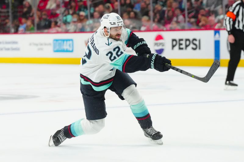 Oct 26, 2023; Raleigh, North Carolina, USA; Seattle Kraken right wing Oliver Bjorkstrand (22) takes a shot against the Carolina Hurricanes in the overtime at PNC Arena. Mandatory Credit: James Guillory-USA TODAY Sports