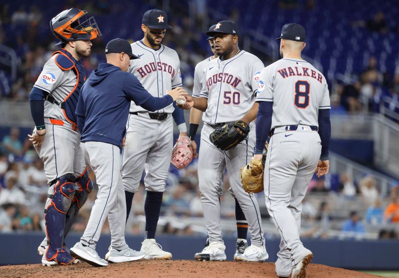 Aug 6, 2025; Miami, Florida, USA;  Houston Astros manager Joe Espada (19) takes the ball from relief pitcher Hector Neris (50) against the Miami Marlins  during the fifth inning at loanDepot Park. Mandatory Credit: Rhona Wise-Imagn Images