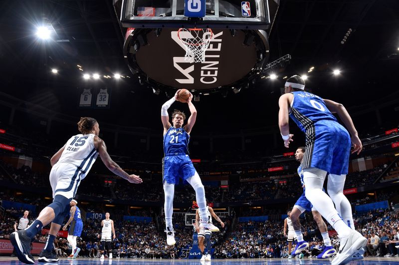 ORLANDO, FL - MARCH 30: Moritz Wagner #21 of the Orlando Magic rebounds the ball during the game against the Memphis Grizzlies on March 30, 2024 at the Kia Center in Orlando, Florida. NOTE TO USER: User expressly acknowledges and agrees that, by downloading and or using this photograph, User is consenting to the terms and conditions of the Getty Images License Agreement. Mandatory Copyright Notice: Copyright 2024 NBAE (Photo by Fernando Medina/NBAE via Getty Images)