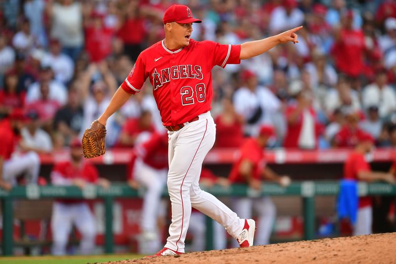 Jul 19, 2023; Anaheim, California, USA; Los Angeles Angels relief pitcher Aaron Loup (28) celebrates the victory against the New York Yankees at Angel Stadium. Mandatory Credit: Gary A. Vasquez-USA TODAY Sports