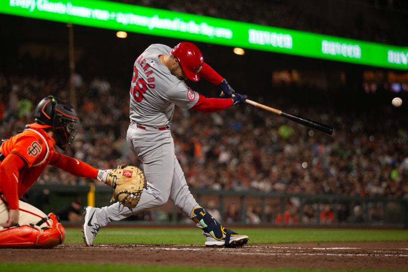 Sep 27, 2024; San Francisco, California, USA; St. Louis Cardinals third baseman Nolan Arenado (28) hits a double against the San Francisco Giants during the fourth inning at Oracle Park. Mandatory Credit: D. Ross Cameron-Imagn Images