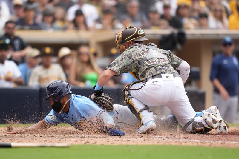 Jun 18, 2023; San Diego, California, USA;  San Diego Padres catcher Austin Nola (26) tags out Tampa Bay Rays center fielder Manuel Margot (13) at home plate during the eighth inning at Petco Park. Mandatory Credit: Ray Acevedo-USA TODAY Sports