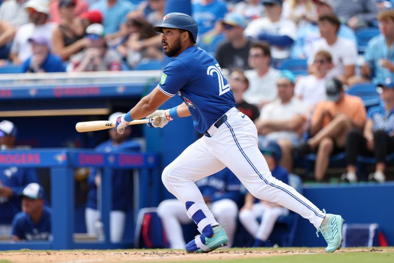 Mar 20, 2025; Dunedin, Florida, USA; Toronto Blue Jays outfielder Anthony Santander (25) hits a two rbi double against the Tampa Bay Rays in the fifth inning during spring training at TD Ballpark. Mandatory Credit: Nathan Ray Seebeck-Imagn Images