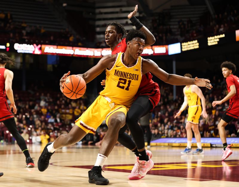 Mar 2, 2023; Minneapolis, Minnesota, USA; Minnesota Golden Gophers forward Pharrel Payne (21) drives to the basket while Rutgers Scarlet Knights forward Antwone Woolfolk (13) defends during the first half at Williams Arena. Mandatory Credit: Matt Krohn-USA TODAY Sports