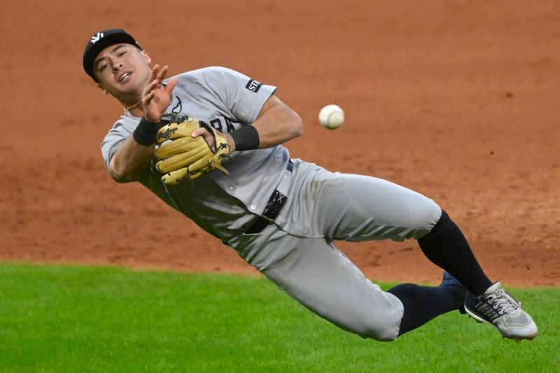 Apr 22, 2025; Cleveland, Ohio, USA; New York Yankees shortstop Anthony Volpe (11) throws to first base in the sixth inning against the Cleveland Guardians at Progressive Field. Mandatory Credit: David Richard-Imagn Images