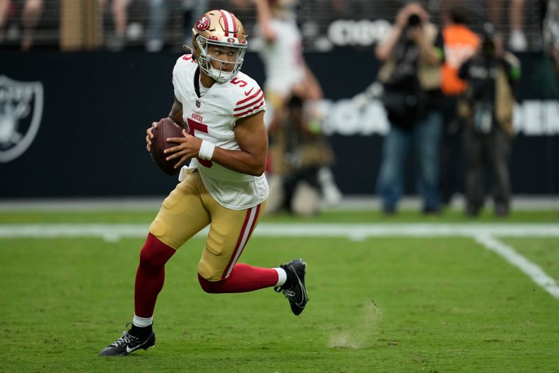 San Francisco 49ers quarterback Trey Lance (5) plays against the Las Vegas Raiders during an NFL football game, Sunday, Aug. 13, 2023, in Las Vegas. (AP Photo/John Locher)