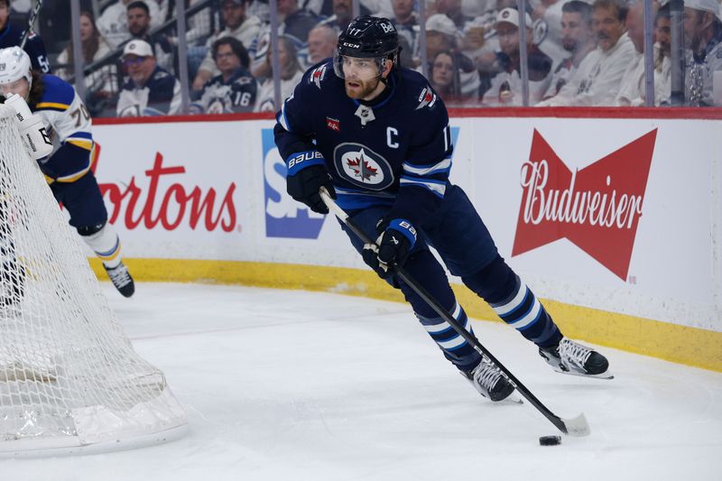 Apr 30, 2025; Winnipeg, Manitoba, CAN; Winnipeg Jets forward Adam Lowry (17) looks to make a pass against the St. Louis Blues during the first period in game five of the first round of the 2025 Stanley Cup Playoffs at Canada Life Centre. Mandatory Credit: Terrence Lee-Imagn Images