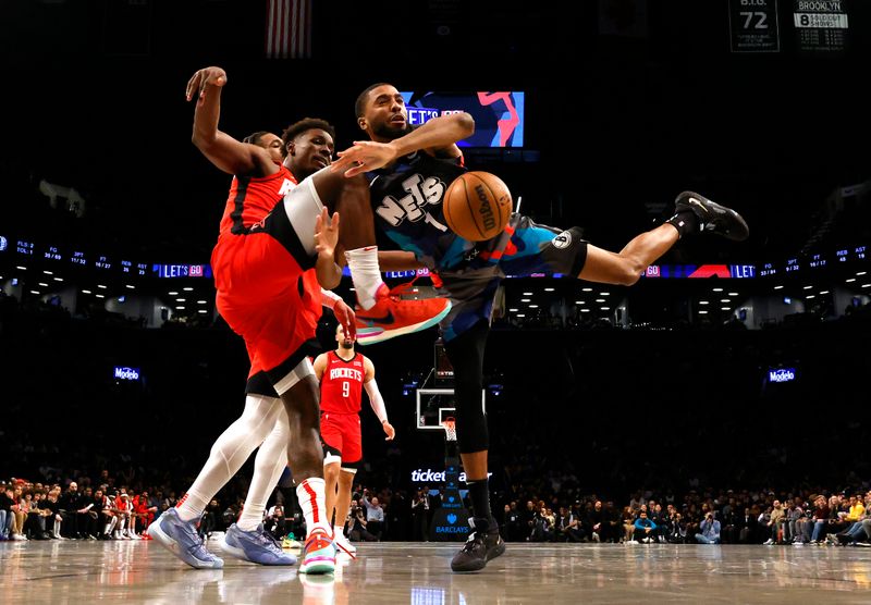 NEW YORK, NEW YORK - JANUARY 27:  Jae'Sean Tate #8 of the Houston Rockets fouls Mikal Bridges #1 of the Brooklyn Nets during their game at Barclays Center on January 27, 2024 in New York City.  User expressly acknowledges and agrees that, by downloading and or using this photograph, User is consenting to the terms and conditions of the Getty Images License Agreement.   (Photo by Al Bello/Getty Images)