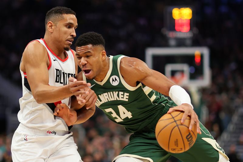 MILWAUKEE, WISCONSIN - NOVEMBER 26: Giannis Antetokounmpo #34 of the Milwaukee Bucks is defended by Malcolm Brogdon #11 of the Portland Trail Blazers during a game at Fiserv Forum on November 26, 2023 in Milwaukee, Wisconsin. NOTE TO USER: User expressly acknowledges and agrees that, by downloading and or using this photograph, User is consenting to the terms and conditions of the Getty Images License Agreement. (Photo by Stacy Revere/Getty Images)