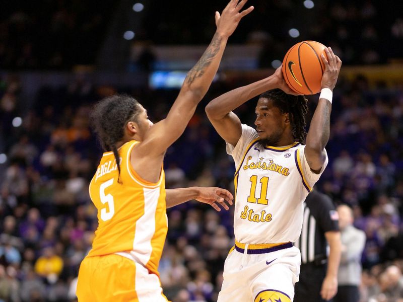 Jan 21, 2023; Baton Rouge, Louisiana, USA;  LSU Tigers guard Justice Williams (11) controls the ball against Tennessee Volunteers guard Zakai Zeigler (5) during the first half at Pete Maravich Assembly Center. Mandatory Credit: Stephen Lew-USA TODAY Sports