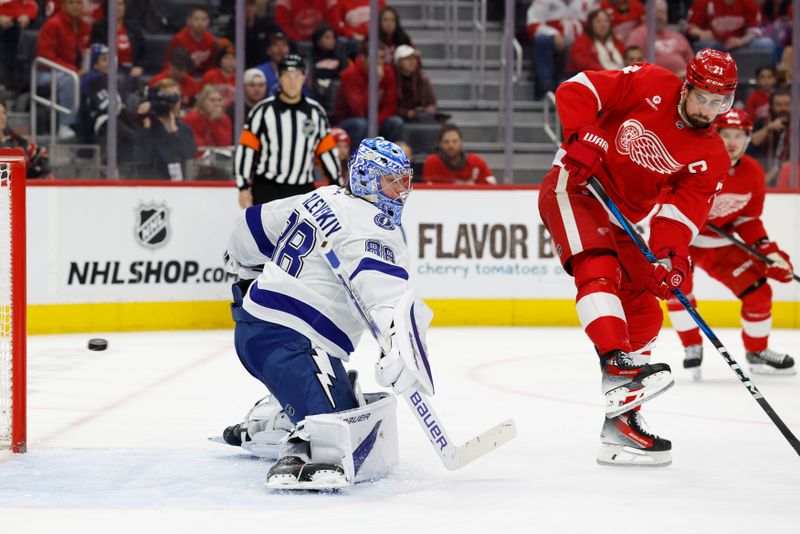 Jan 25, 2025; Detroit, Michigan, USA;  Tampa Bay Lightning goaltender Andrei Vasilevskiy (88) makes a save on Detroit Red Wings center Dylan Larkin (71) in the second period at Little Caesars Arena. Mandatory Credit: Rick Osentoski-Imagn Images