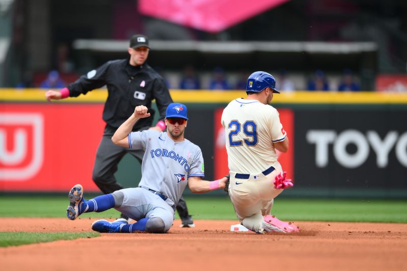 May 11, 2025; Seattle, Washington, USA; Toronto Blue Jays second baseman Ernie Clement (22) tags out Seattle Mariners designated hitter Cal Raleigh (29) at second base during a stolen base attempt in the third inning at T-Mobile Park. Mandatory Credit: Steven Bisig-Imagn Images
