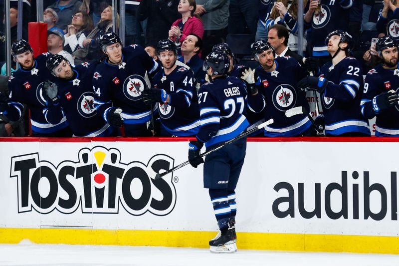 Apr 16, 2024; Winnipeg, Manitoba, CAN;  Winnipeg Jets forward Nikolaj Ehlers (27) is congratulated after a goal against the Seattle Kraken during the second period at Canada Life Centre. Mandatory Credit: Terrence Lee-USA TODAY Sports