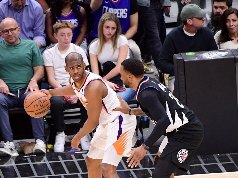LOS ANGELES, CA - APRIL 22:  Chris Paul #3 of the Phoenix Suns dribbles the ball against the LA Clippers during Round 1 Game 4 of the 2023 NBA Playoffs on April 22, 2023 at Crypto.Com Arena in Los Angeles, California. NOTE TO USER: User expressly acknowledges and agrees that, by downloading and/or using this Photograph, user is consenting to the terms and conditions of the Getty Images License Agreement. Mandatory Copyright Notice: Copyright 2023 NBAE (Photo by Adam Pantozzi/NBAE via Getty Images)