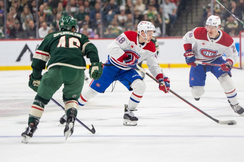 Nov 14, 2024; Saint Paul, Minnesota, USA; Montreal Canadiens defenseman Lane Hutson (48) takes the puck into the Minnesota Wild zone as defenseman Jared Spurgeon (46) is back on defense in the first period at Xcel Energy Center. Mandatory Credit: Matt Blewett-Imagn Images