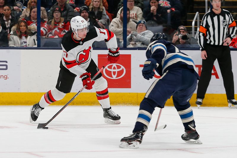 Jan 19, 2024; Columbus, Ohio, USA; New Jersey Devils defenseman Simon Nemec (17) wrists a shot on goal as Columbus Blue Jackets defenseman Damon Severson (78) defends during the second period at Nationwide Arena. Mandatory Credit: Russell LaBounty-USA TODAY Sports