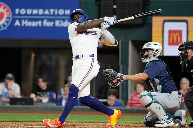 Apr 24, 2024; Arlington, Texas, USA; Texas Rangers right fielder Adolis García (53) hits a single against the Seattle Mariners during the seventh inning at Globe Life Field. Mandatory Credit: Jim Cowsert-USA TODAY Sports