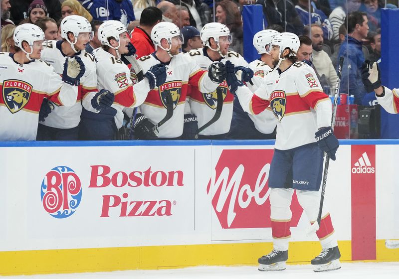 Nov 28, 2023; Toronto, Ontario, CAN; Florida Panthers center Kevin Stenlund (82) celebrates at the bench after scoring a goal against the Toronto Maple Leafs during the first period at Scotiabank Arena. Mandatory Credit: Nick Turchiaro-USA TODAY Sports