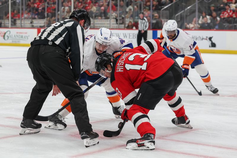 Nov 10, 2025; Newark, New Jersey, USA; New Jersey Devils center Nico Hischier (13) and New York Islanders center Jean-Gabriel Pageau (44) face off during the third period at Prudential Center. Mandatory Credit: Ed Mulholland-Imagn Images