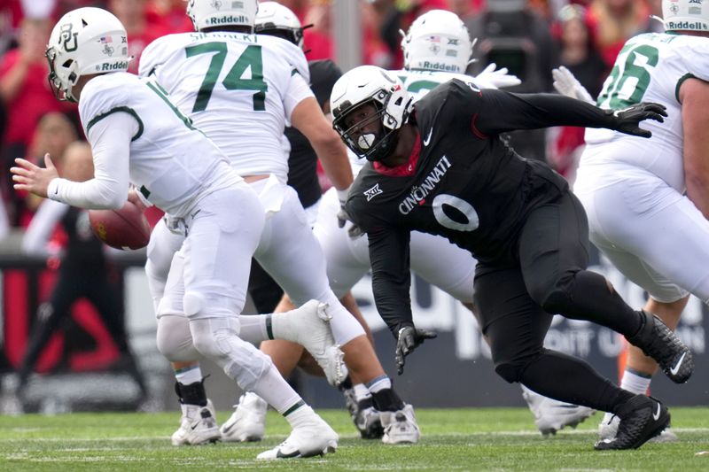 Oct 21, 2023; Cincinnati, Ohio, USA; Cincinnati Bearcats defensive end Jowon Briggs (0) pressures Baylor Bears quarterback Blake Shapen (12) in the first half at Nippert Stadium. Mandatory Credit: Kareem Elgazzar-USA TODAY Sports