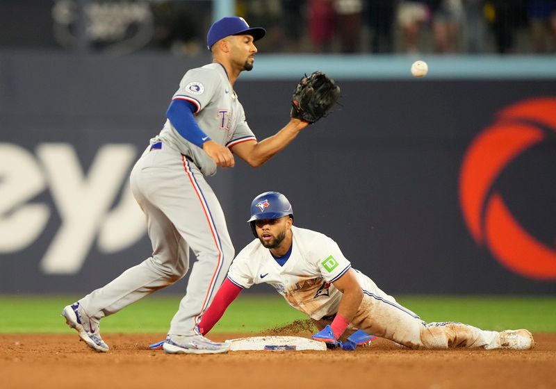 Jul 26, 2024; Toronto, Ontario, CAN; Toronto Blue Jays outfielder Steward Berrora (37) steals second base on Texas Rangers second baseman Marcus Semien (2) during the ninth inning at Rogers Centre. Mandatory Credit: John E. Sokolowski-USA TODAY Sports