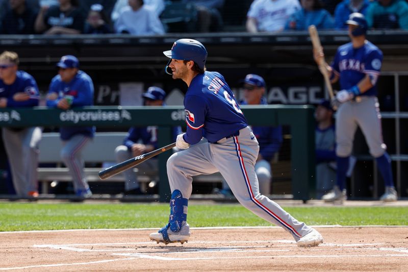 May 24, 2025; Chicago, Illinois, USA; Texas Rangers shortstop Josh Smith (8) hits an RBI-double against the Chicago White Sox during the first inning at Rate Field. Mandatory Credit: Kamil Krzaczynski-Imagn Images