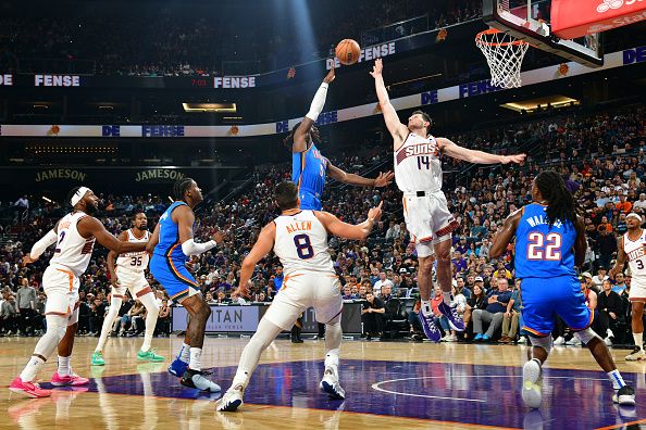 PHOENIX, AZ - NOVEMBER  12:  Drew Eubanks #14 of the Phoenix Suns plays defense against Luguentz Dort #5 of the Oklahoma City Thunder on November 12, 2023 at Footprint Center in Phoenix, Arizona. NOTE TO USER: User expressly acknowledges and agrees that, by downloading and or using this photograph, user is consenting to the terms and conditions of the Getty Images License Agreement. Mandatory Copyright Notice: Copyright 2023 NBAE (Photo by Kate Frese/NBAE via Getty Images)