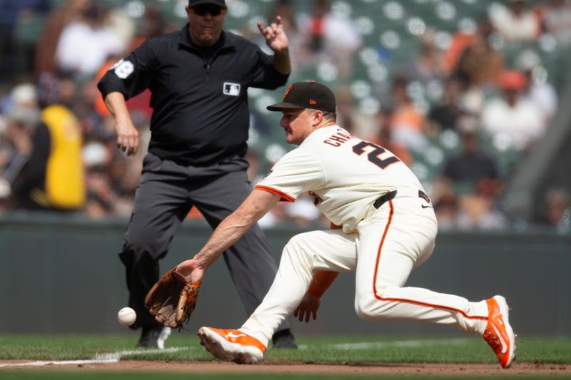 Sep 10, 2025; San Francisco, California, USA; San Francisco Giants third baseman Matt Chapman (26) backhands an infield single by Arizona Diamondbacks first baseman Tim Tawa (not pictured) during the sixth inning at Oracle Park. Umpire is Doug Eddings. Mandatory Credit: D. Ross Cameron-Imagn Images