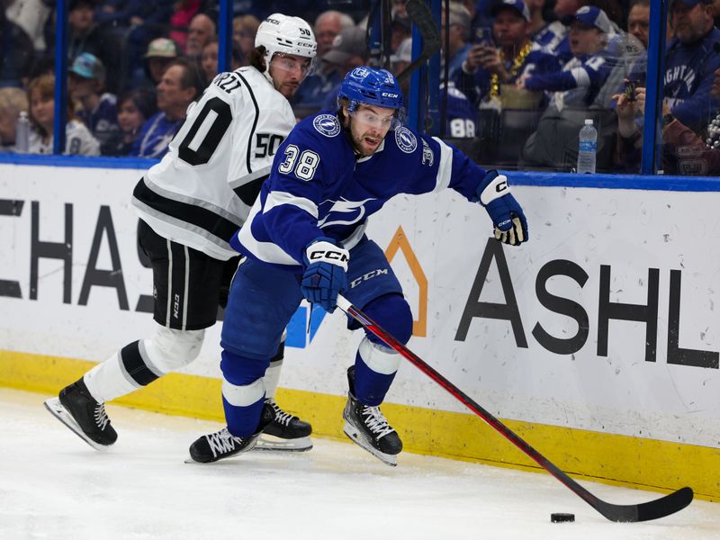 Jan 28, 2023; Tampa, Florida, USA;  Tampa Bay Lightning left wing Brandon Hagel (38) controls the puck from Los Angeles Kings defenseman Sean Durzi (50) in the third period at Amalie Arena. Mandatory Credit: Nathan Ray Seebeck-USA TODAY Sports