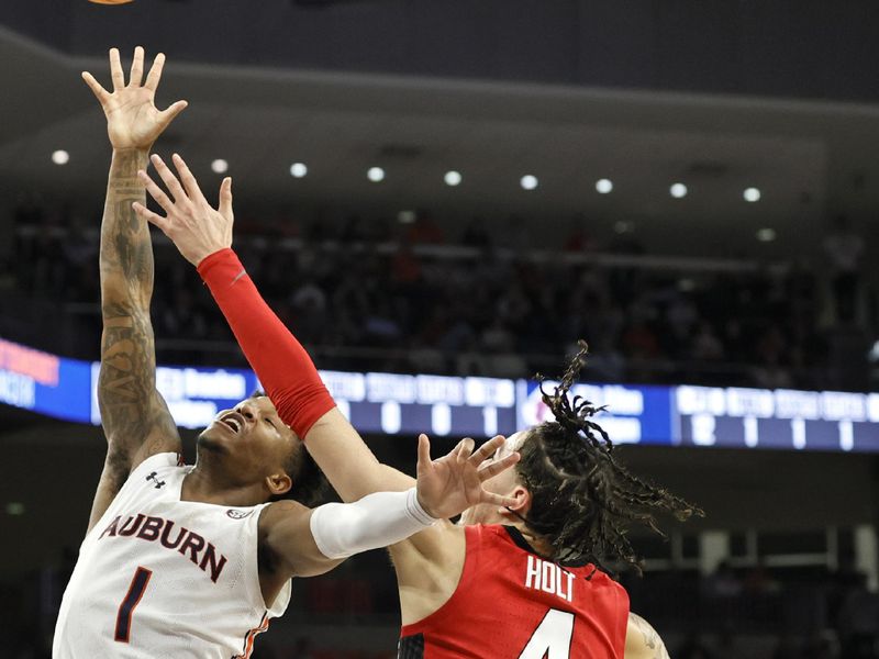 Feb 1, 2023; Auburn, Alabama, USA;  Georgia Bulldogs guard Jusaun Holt (4) moves in against Auburn Tigers guard Wendell Green Jr. (1) during the second half at Neville Arena. Mandatory Credit: John Reed-USA TODAY Sports