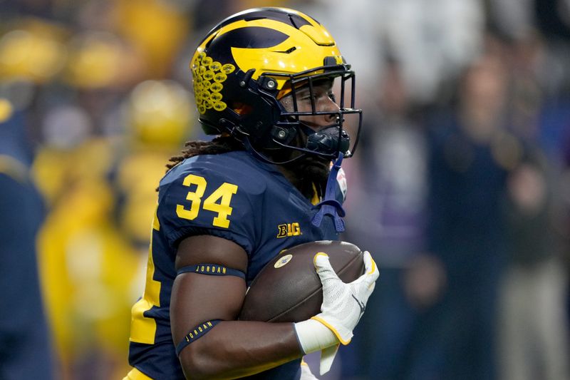 Dec 31, 2022; Glendale, Arizona, USA; Michigan Wolverines running back Leon Franklin (34) warms up before their game against the TCU Horned Frogs in the 2022 Fiesta Bowl at State Farm Stadium. Mandatory Credit: Joe Camporeale-USA TODAY Sports