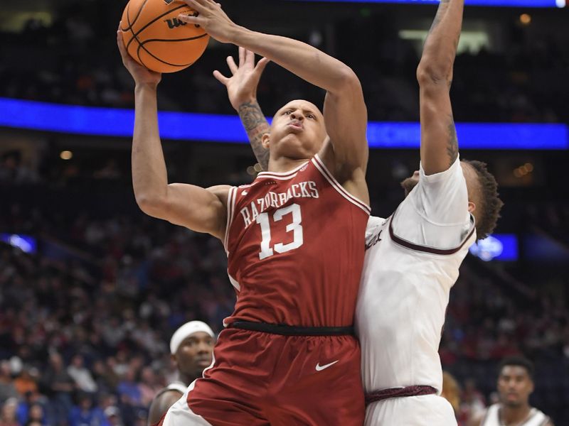 Mar 10, 2023; Nashville, TN, USA; Arkansas Razorbacks guard Jordan Walsh (13) shoots past Arkansas Razorbacks guard Anthony Black (0) during the first half at Bridgestone Arena. Mandatory Credit: Steve Roberts-USA TODAY Sports